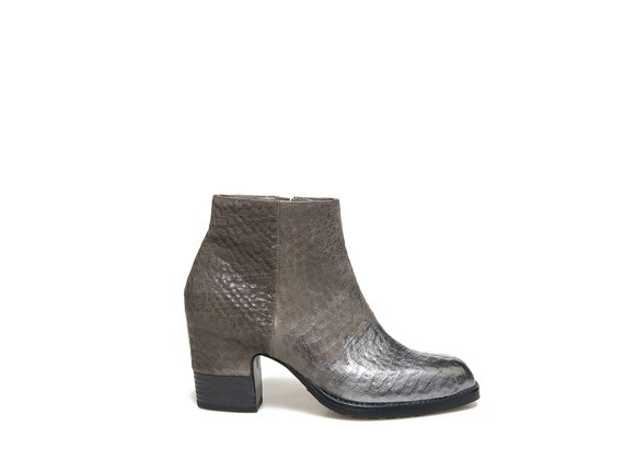 Ankle boot with metallic toe and partially shell shaped heel