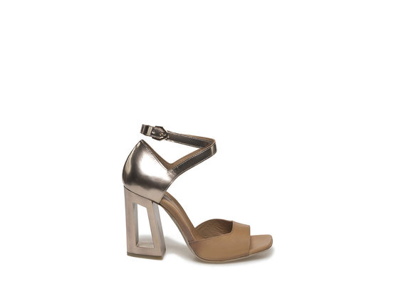 Sandal with golden, perforated heel
