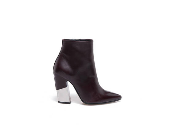 Burgundy pointed toe ankle boots with partially-covered metal shell-shaped heel